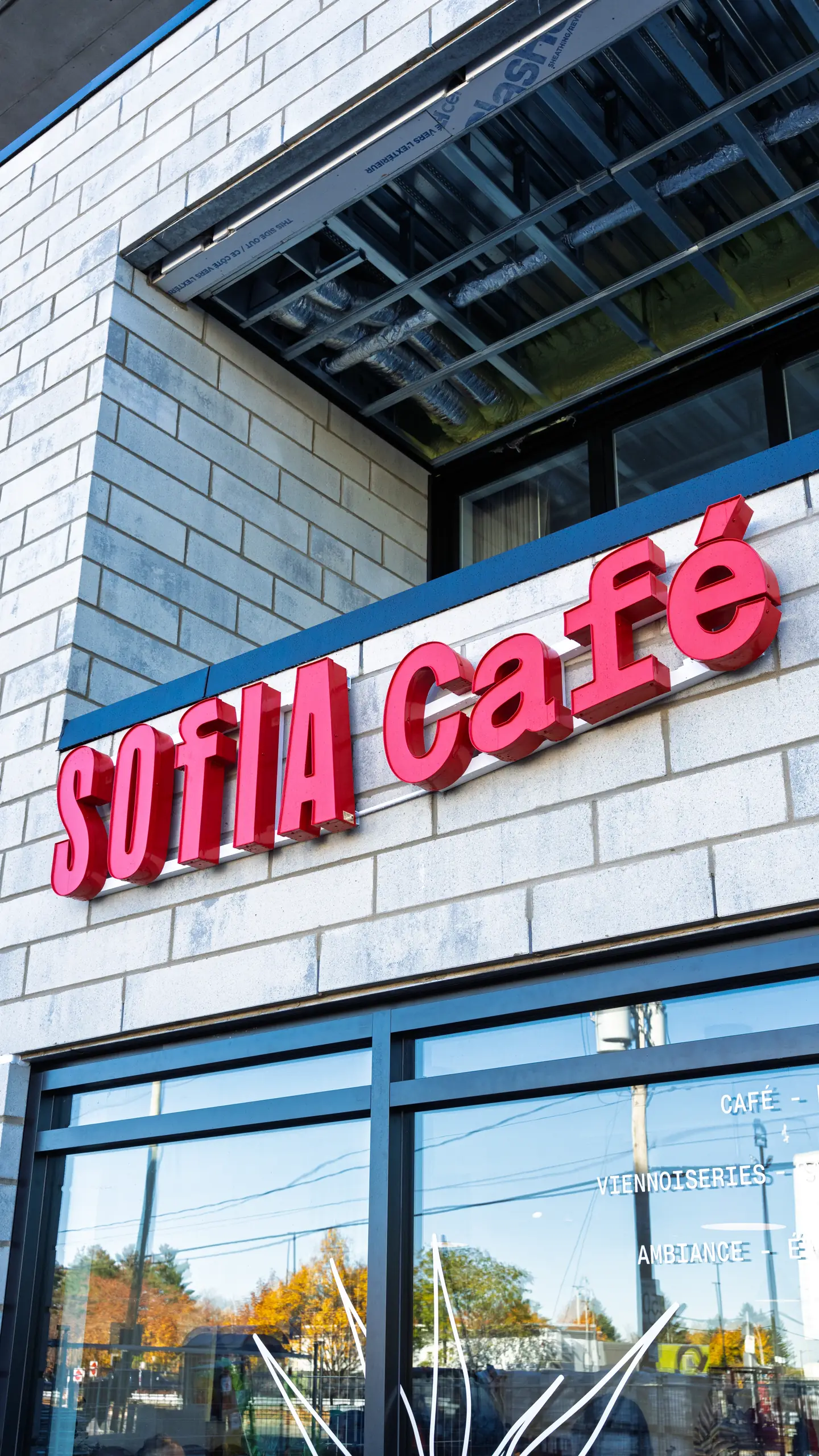 The red Sofia Café sign on the brick front
