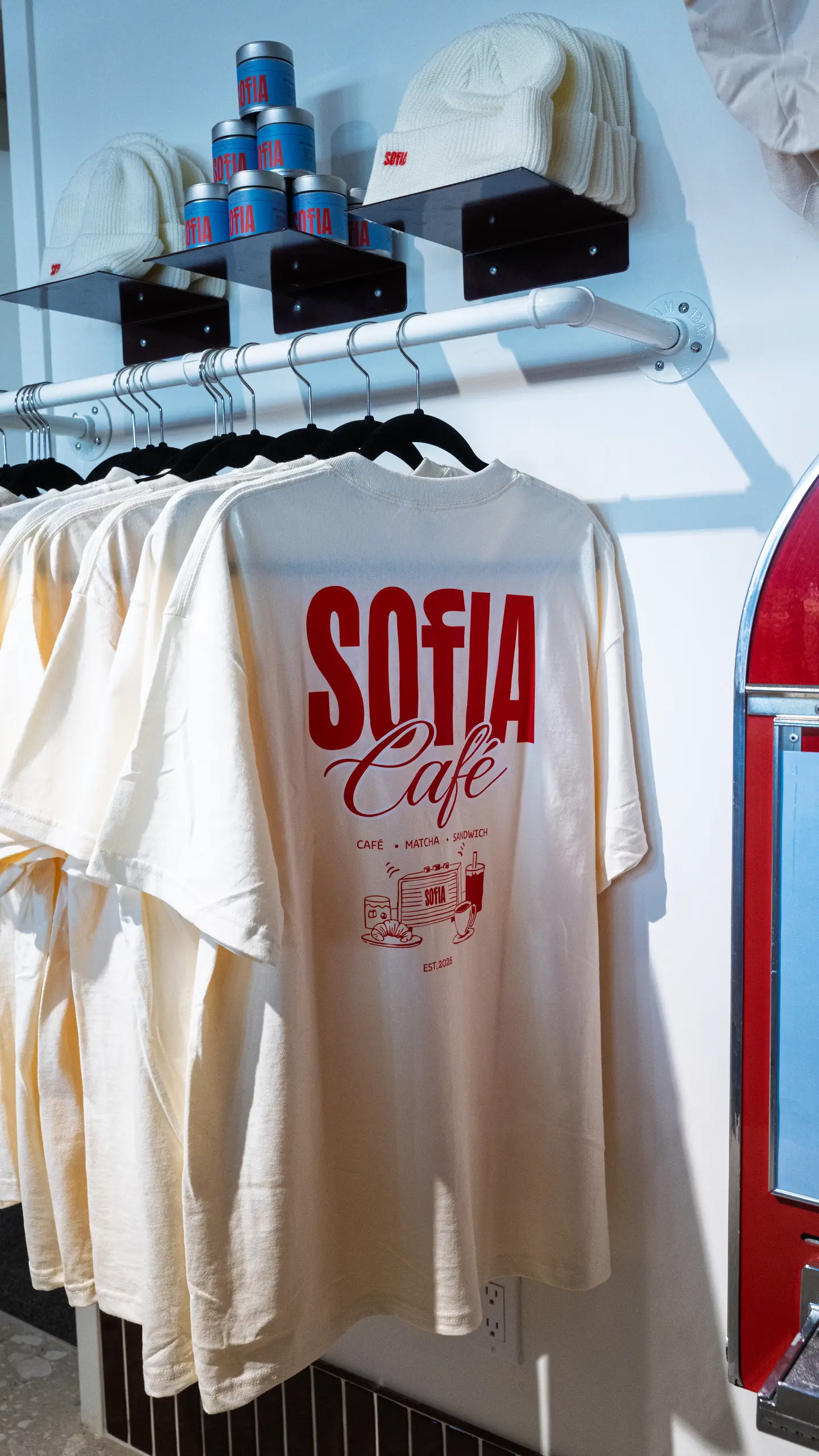The brand's T-shirts and beanies, for sale at the café