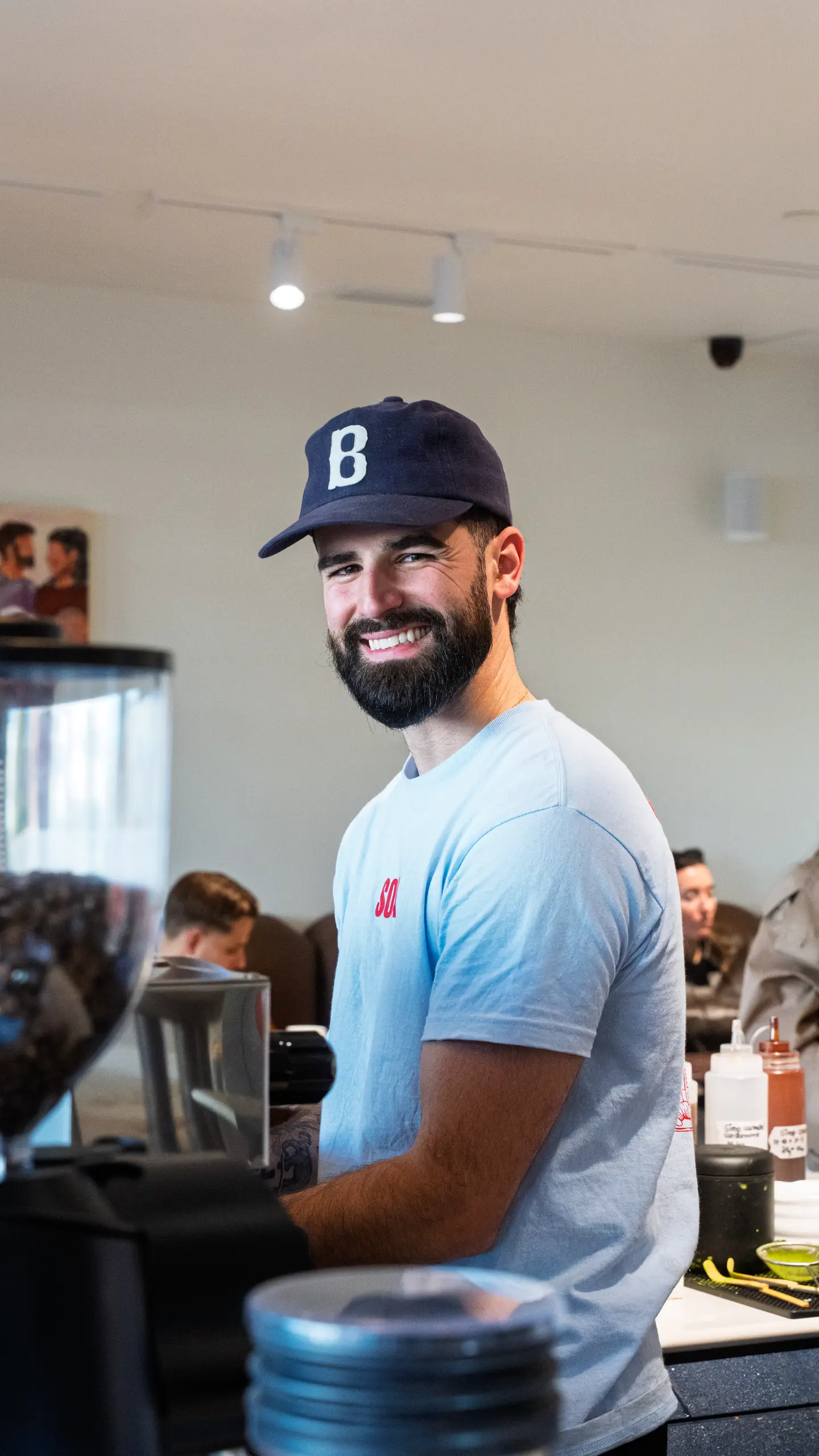 A smiling barista behind the counter