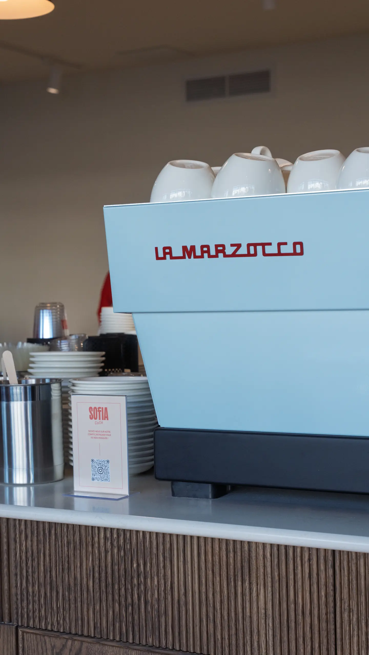 The espresso machine and cups on the counter